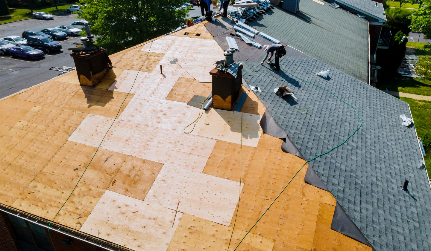 A couple of men working on a roof